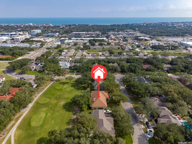 an aerial view of residential houses with outdoor space