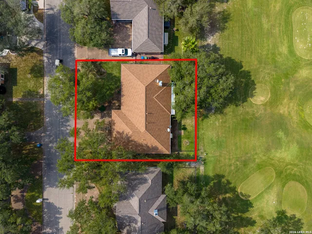 an aerial view of street and residential houses