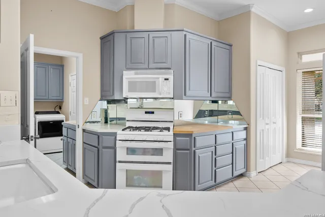 a kitchen with a stove sink and cabinets