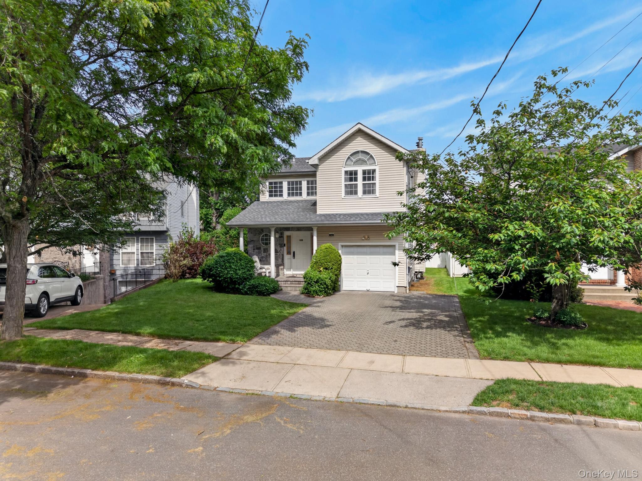 82 B Inwood Road Port Washington, NY 11050 - Photo 2 of 41 a front view of a house with garden