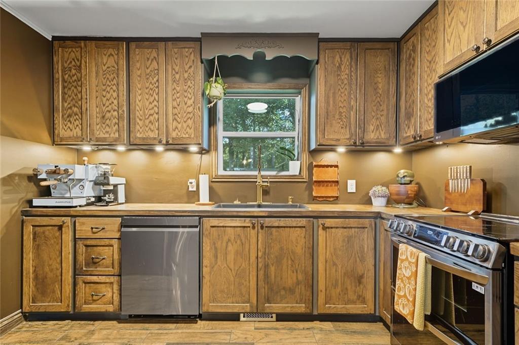 275 Old Whitestone Road West Talking Rock, GA 30175 - Photo 12 of 30 a kitchen with stainless steel appliances granite countertop a stove a sink and a microwave