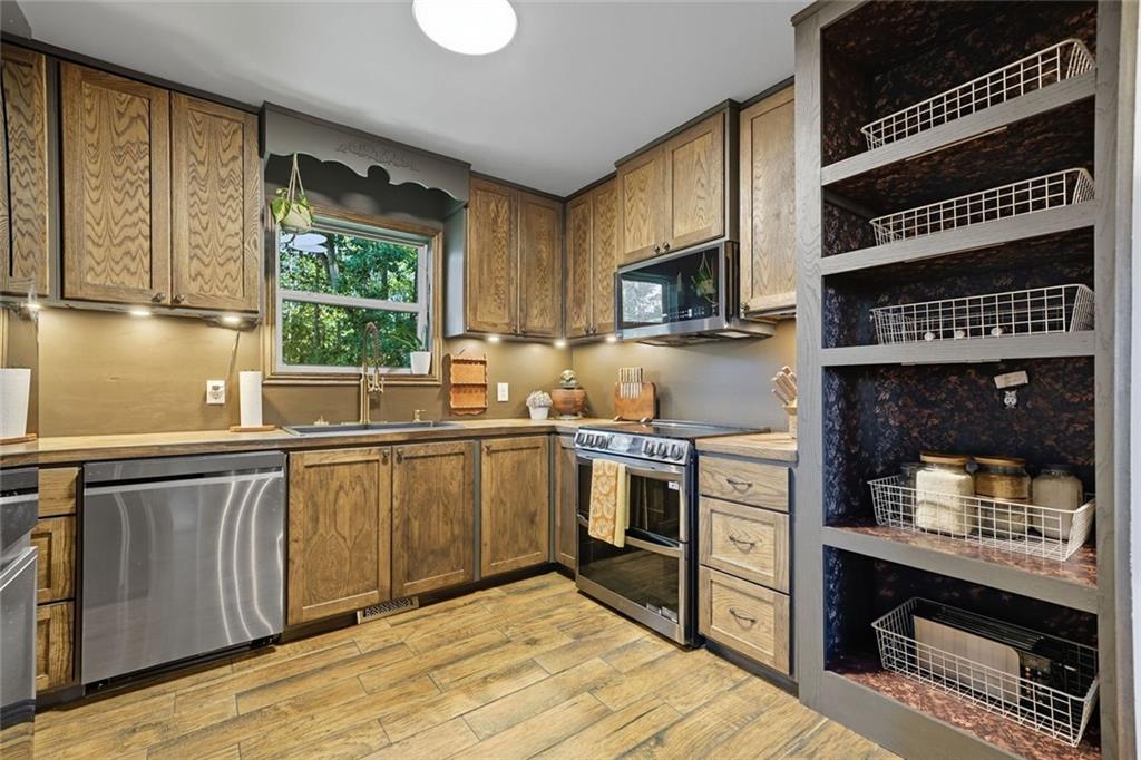 275 Old Whitestone Road West Talking Rock, GA 30175 - Photo 13 of 30 a kitchen with stainless steel appliances a stove sink and cabinets