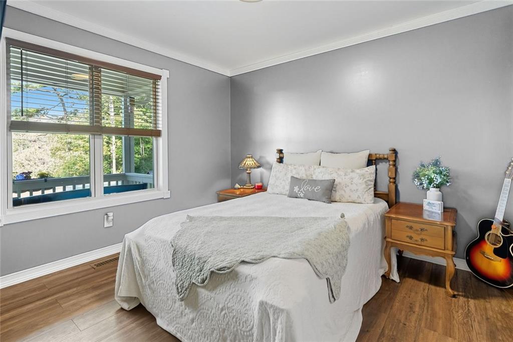 275 Old Whitestone Road West Talking Rock, GA 30175 - Photo 14 of 30 a bed sitting in a bedroom next to a window