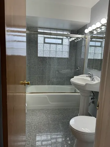 a bathroom with a sink toilet and shower