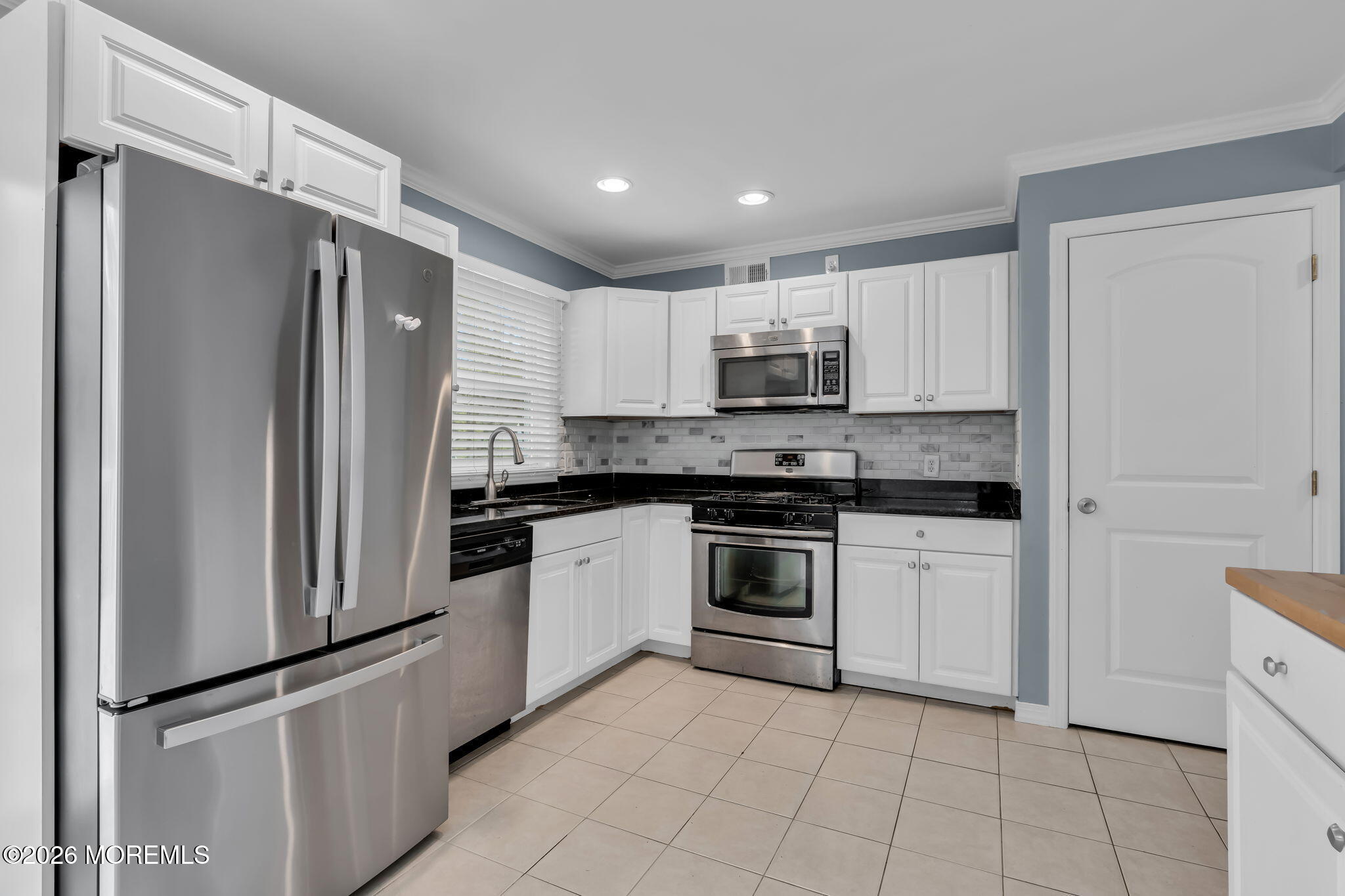 593 Beach Plum Road Brick, NJ 08723 - Photo 16 of 38 a kitchen with cabinets and stainless steel appliances