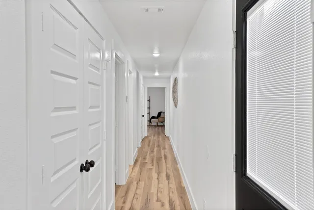 a view of a hallway with a wooden floor