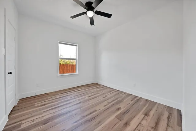 wooden floor in an empty room with a window