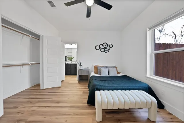 a bedroom with a bed and wooden floor