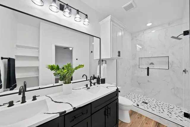 a bathroom with a shower sink and mirror