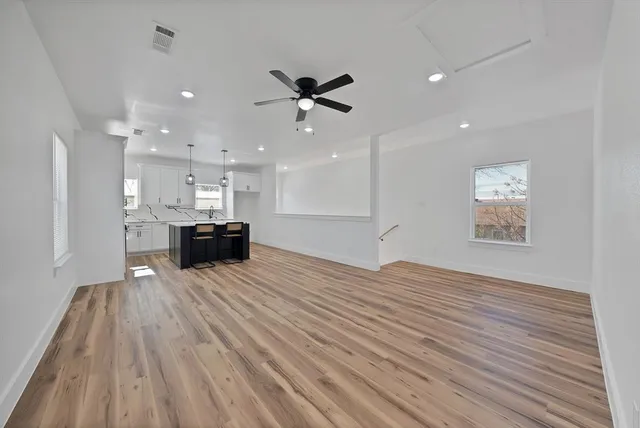 a view of kitchen and kitchen with furniture wooden floor