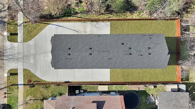 an aerial view of a house with a yard