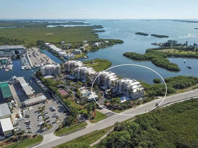 an aerial view of a house with a garden and lake view
