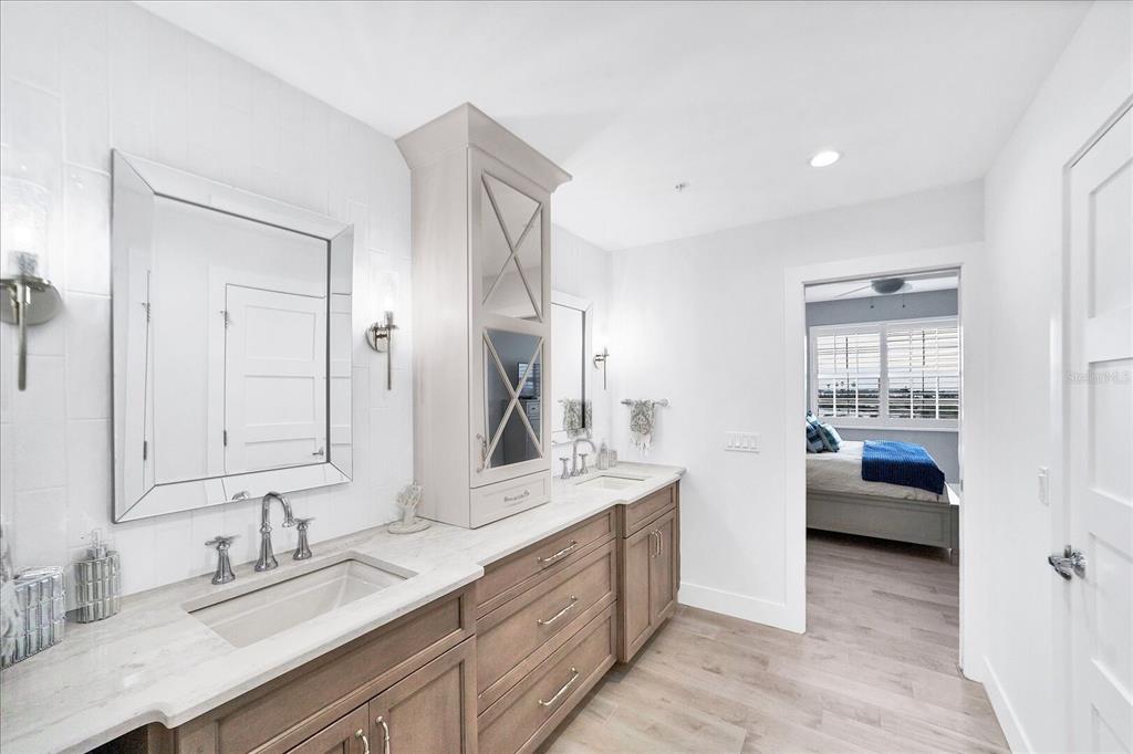 13113 Gasparilla Road, Unit 405 Placida, FL 33946 - Photo 12 of 23 a en suite bathroom with a granite countertop double vanity sink and a mirror
