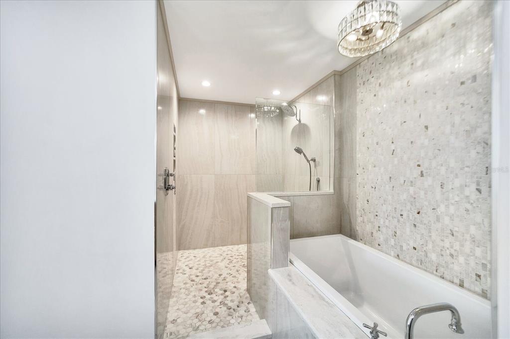 13113 Gasparilla Road, Unit 405 Placida, FL 33946 - Photo 13 of 23 a bathroom with a tub a sink and a shower