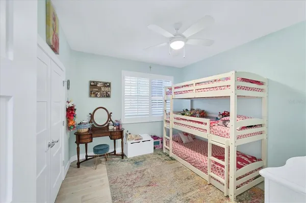 a bedroom with furniture and a fan