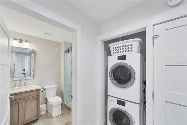 a spacious bathroom with a toilet a sink and a mirror