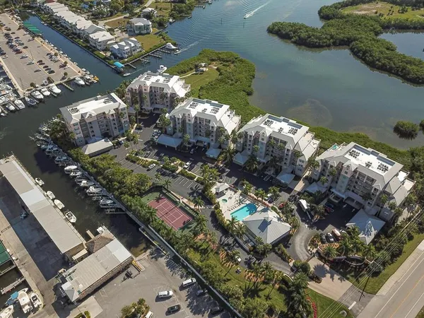 an aerial view of a residential houses with yard