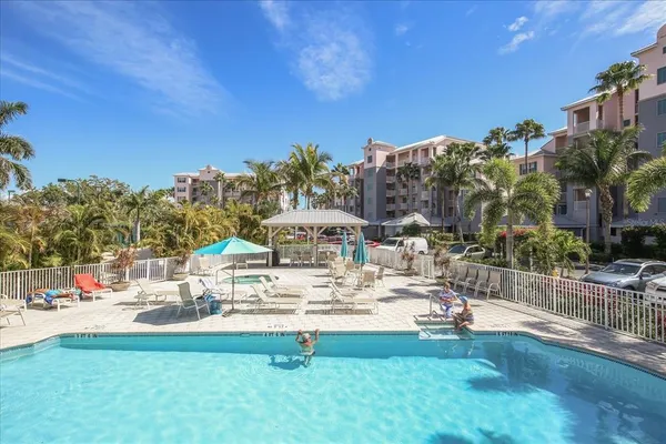 a swimming pool with outdoor seating and yard