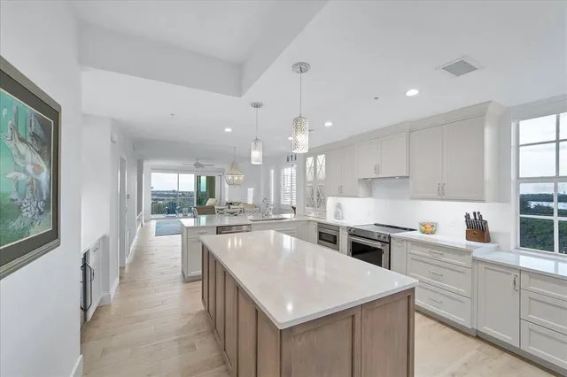 a kitchen with a stove a sink a microwave and cabinets