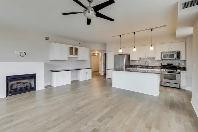 a large kitchen with cabinets and stainless steel appliances