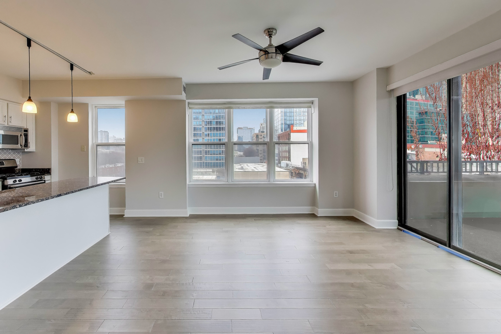 5 East 14th Place, Unit 501 Chicago, IL 60605 - Photo 15 of 37 a view of an empty room with a window and wooden floor