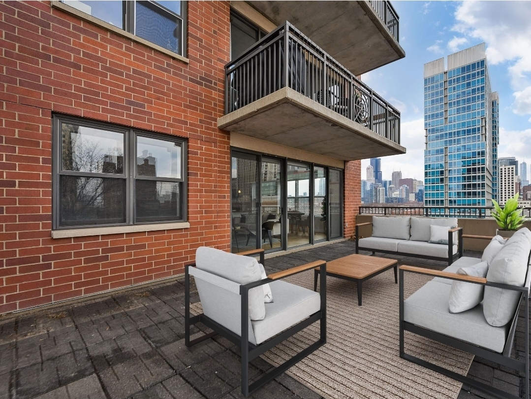 5 East 14th Place, Unit 501 Chicago, IL 60605 - Photo 30 of 37 a view of a patio with couches table and chairs and potted plants
