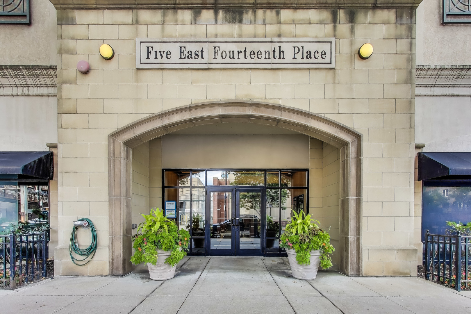 5 East 14th Place, Unit 501 Chicago, IL 60605 - Photo 8 of 37 a front view of a building with potted plants