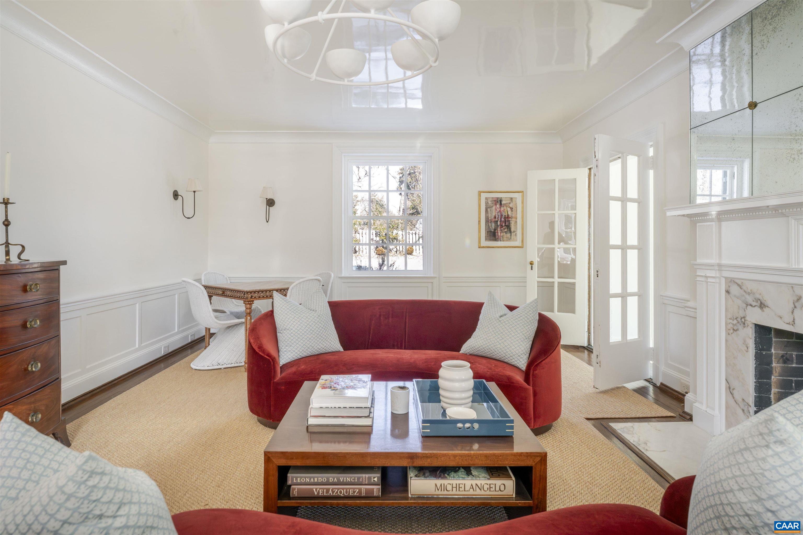 921 Rugby Road Charlottesville, VA 22903 - Photo 11 of 41 a living room with furniture a fireplace and a chandelier