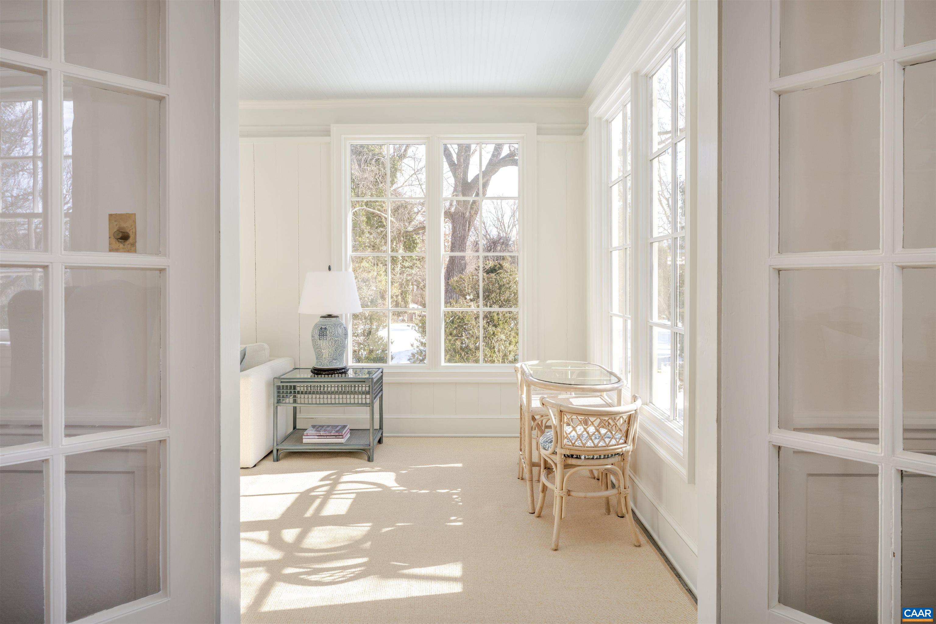 921 Rugby Road Charlottesville, VA 22903 - Photo 17 of 41 a living room with furniture and a large window