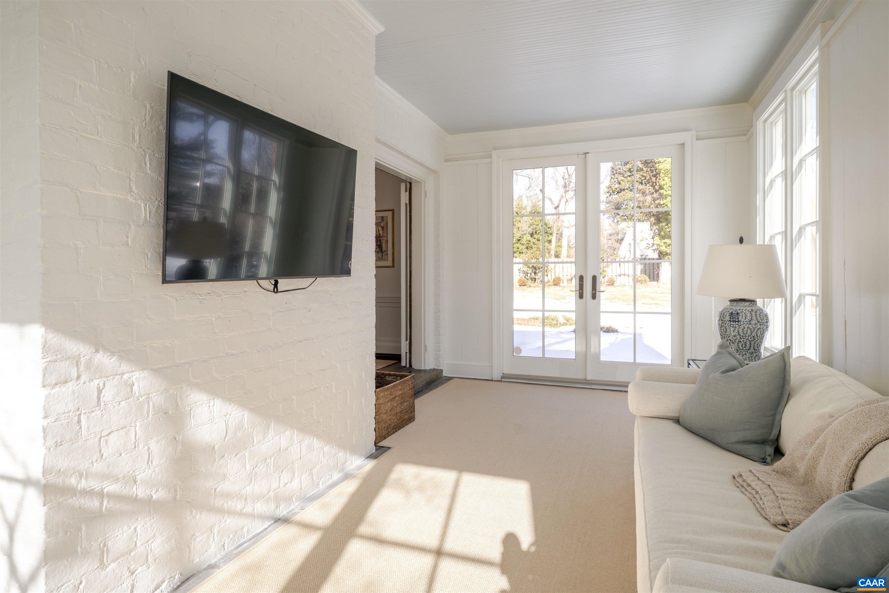 921 Rugby Road Charlottesville, VA 22903 - Photo 18 of 41 a living room with furniture and a flat screen tv