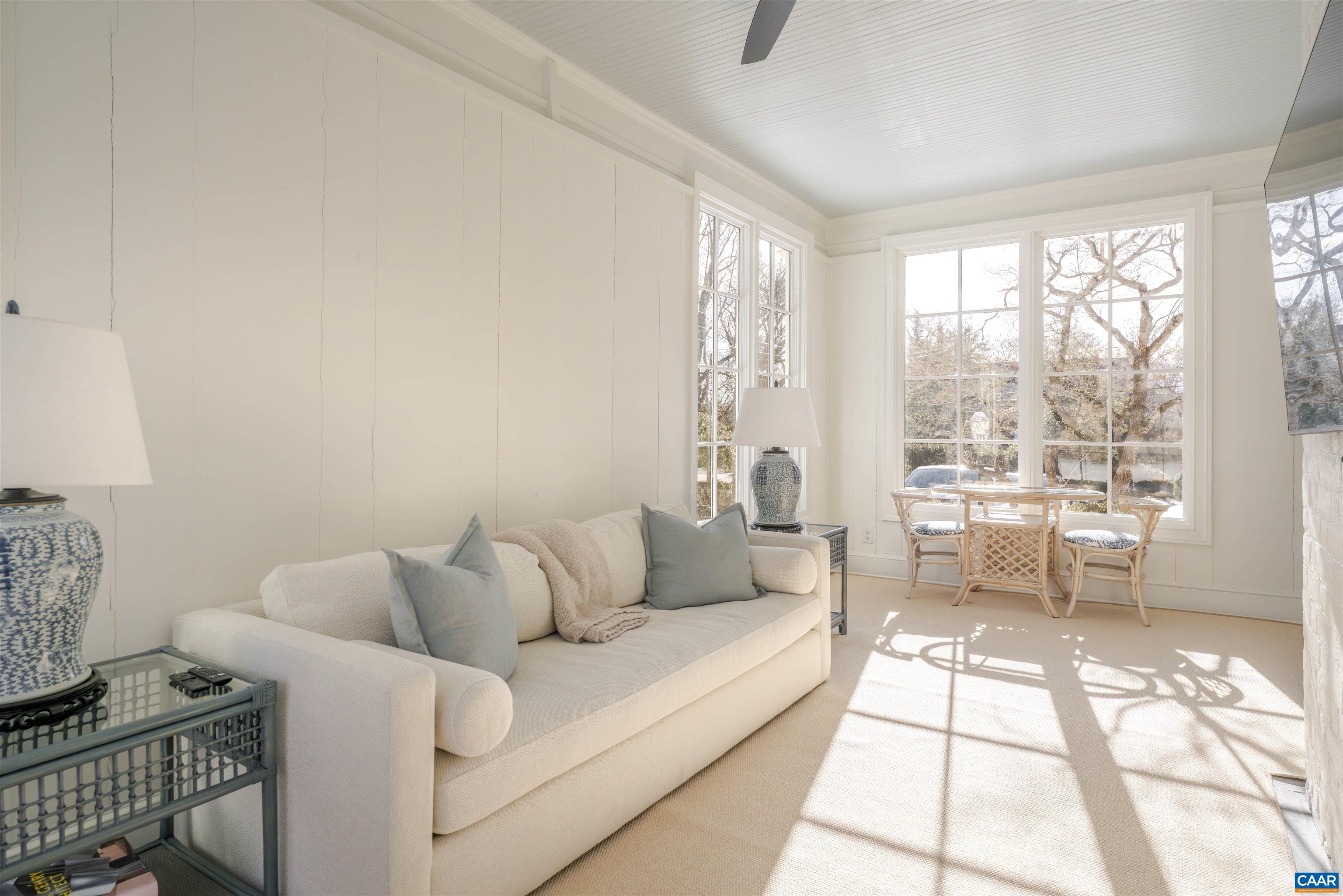 921 Rugby Road Charlottesville, VA 22903 - Photo 19 of 41 a living room with furniture and a floor to ceiling window