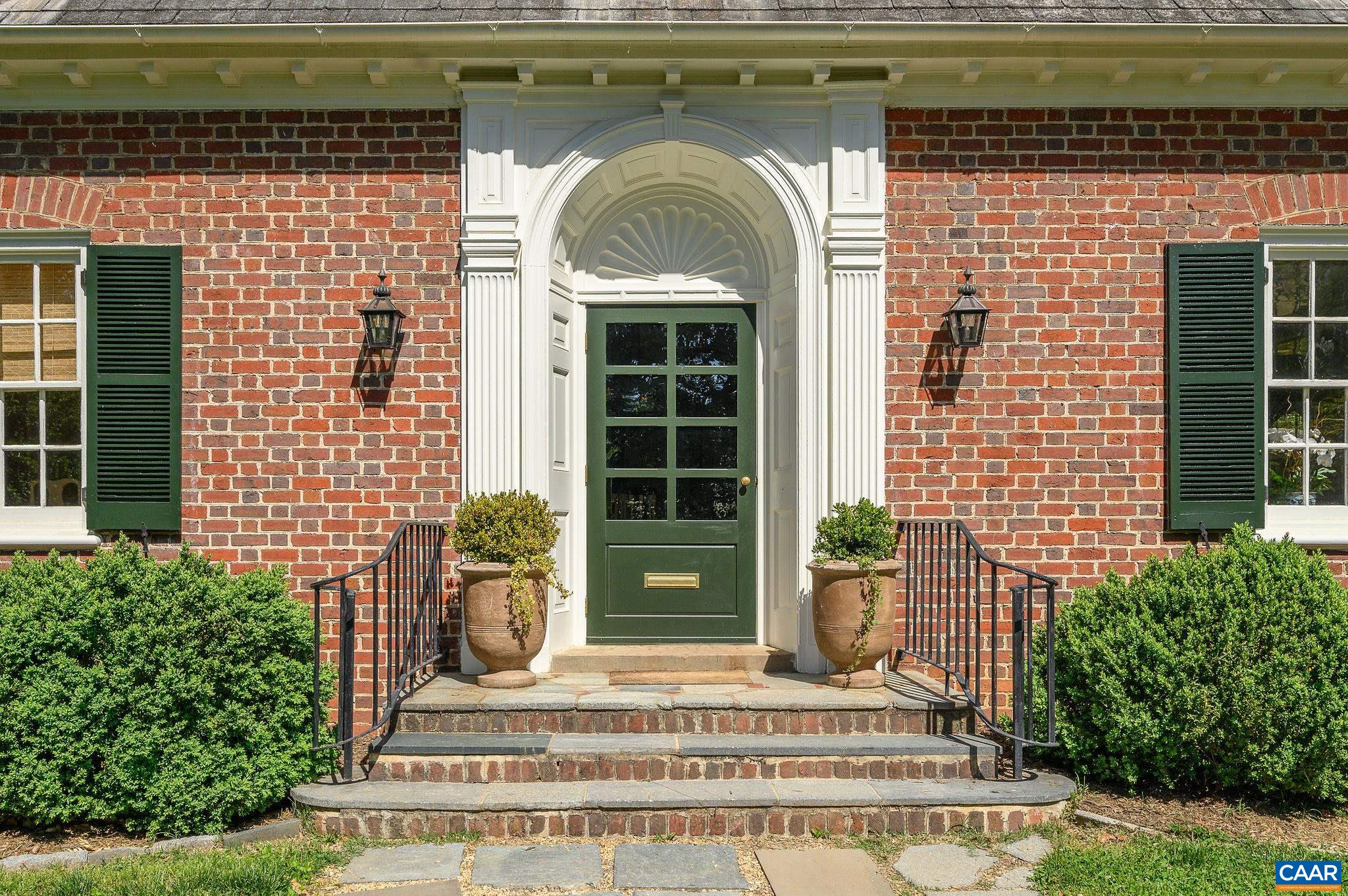 921 Rugby Road Charlottesville, VA 22903 - Photo 2 of 41 a front view of a house with potted plants