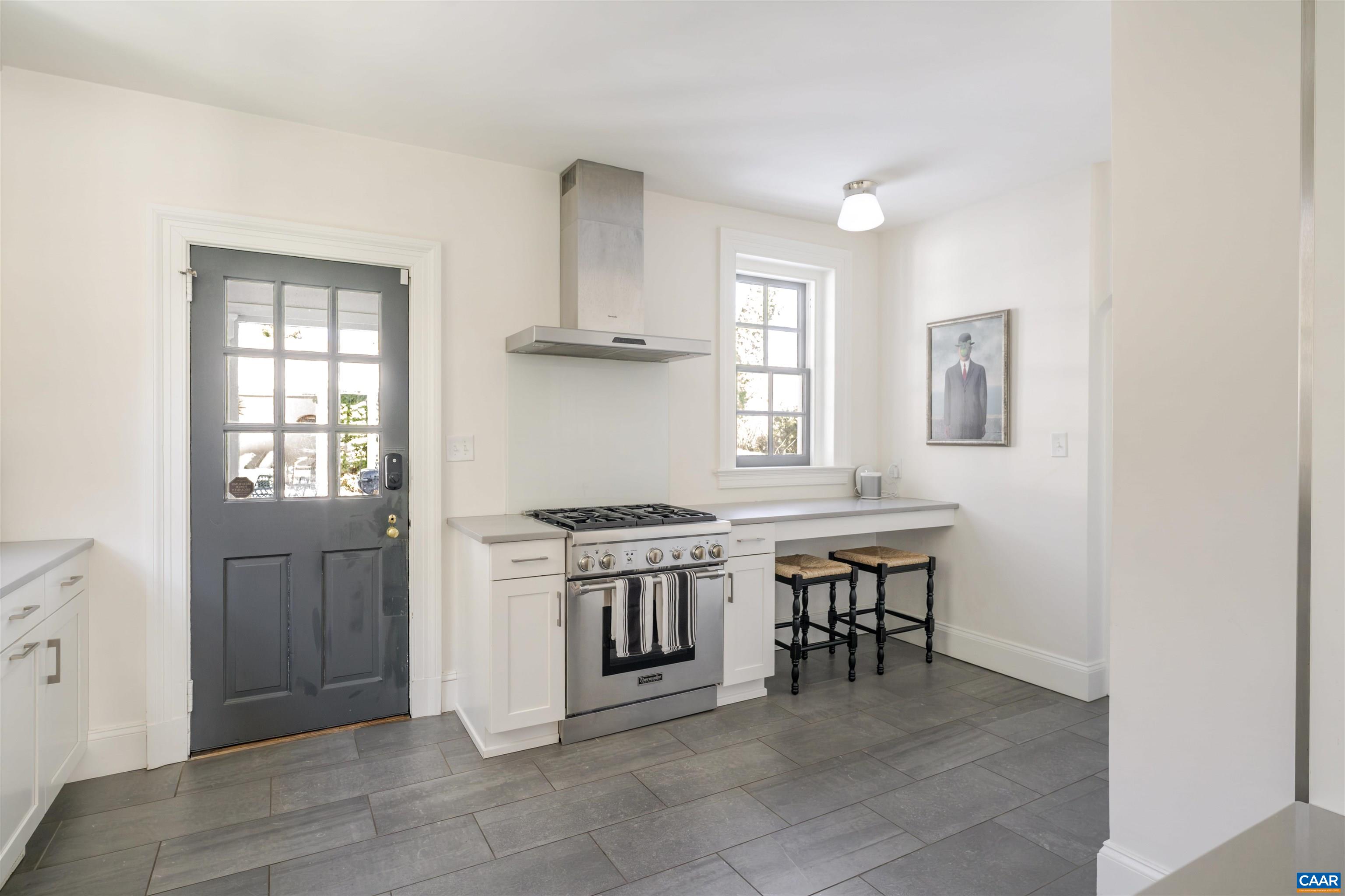 921 Rugby Road Charlottesville, VA 22903 - Photo 22 of 41 a kitchen with a stove a sink and a refrigerator