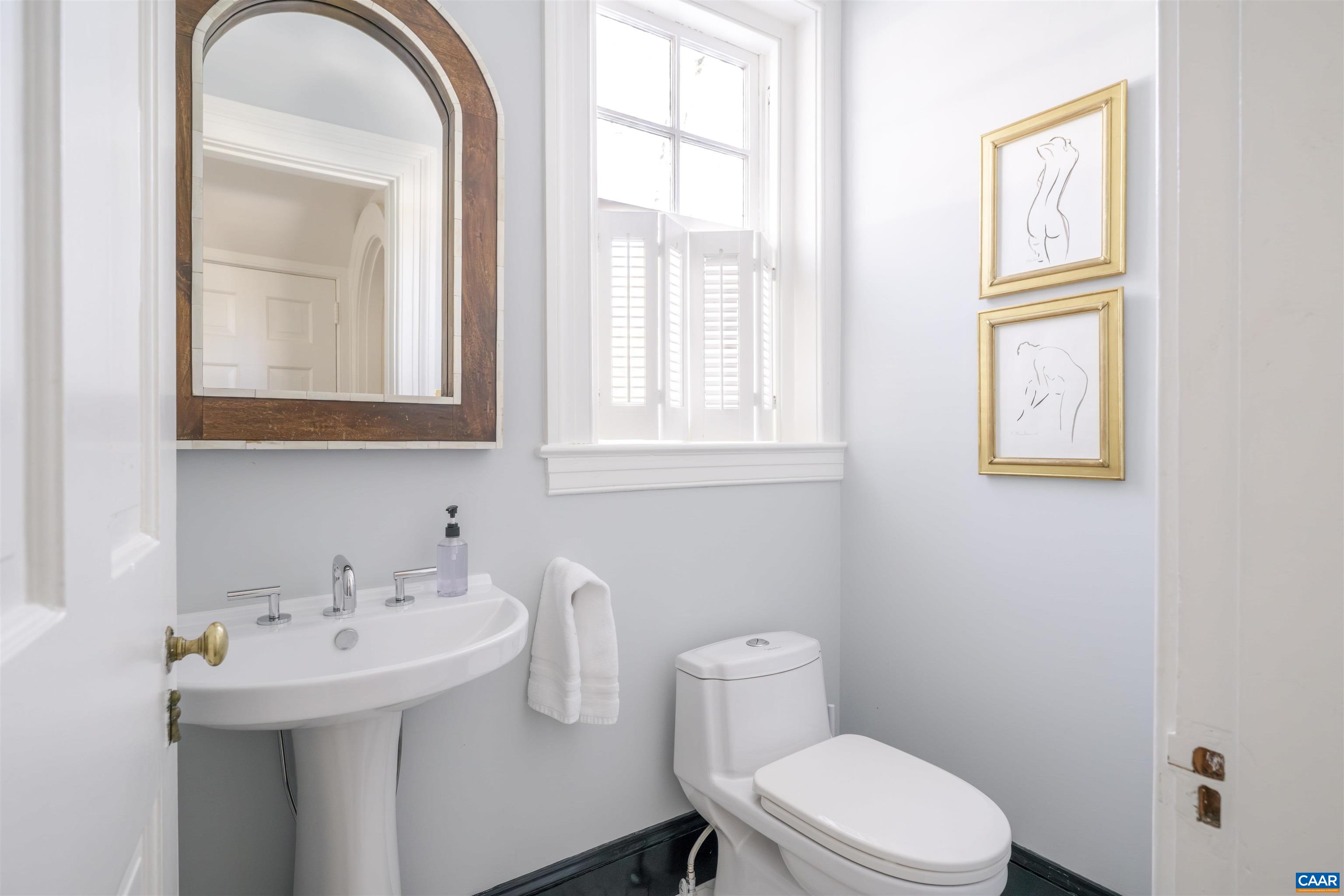 921 Rugby Road Charlottesville, VA 22903 - Photo 25 of 41 a bathroom with a toilet a sink and mirror