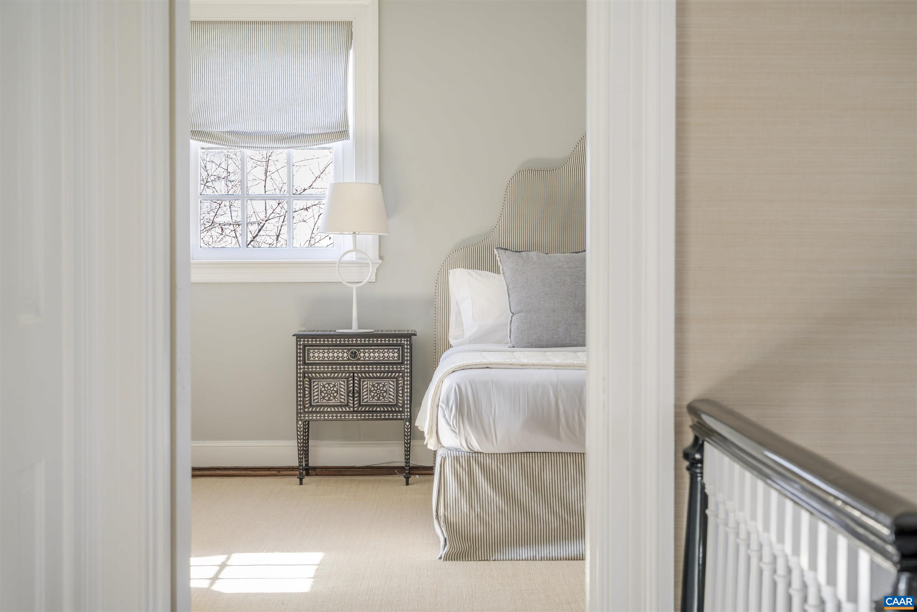 921 Rugby Road Charlottesville, VA 22903 - Photo 26 of 41 a bedroom with a bed and a window