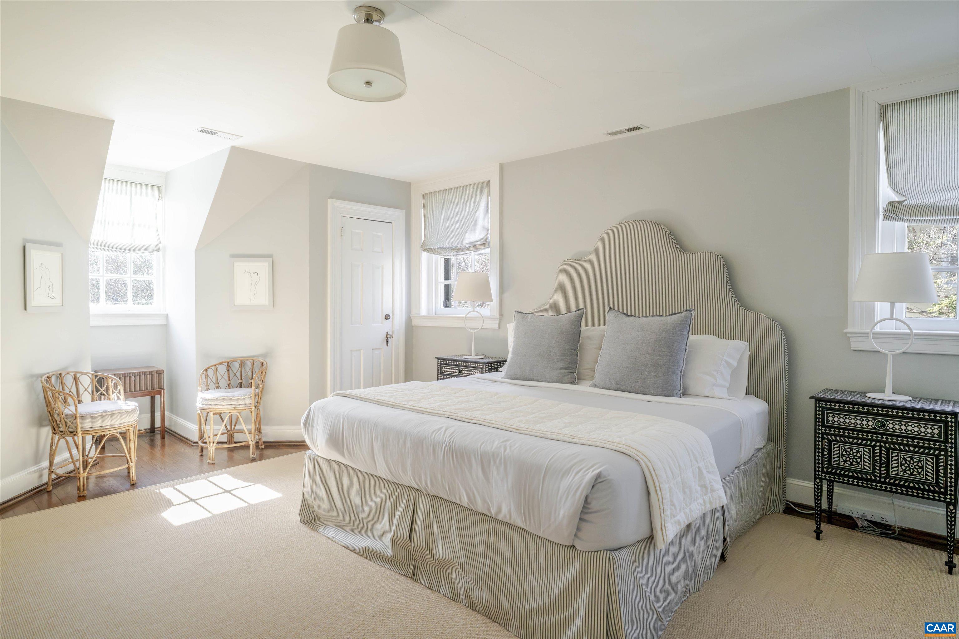 921 Rugby Road Charlottesville, VA 22903 - Photo 27 of 41 a bedroom with a bed a table and chair