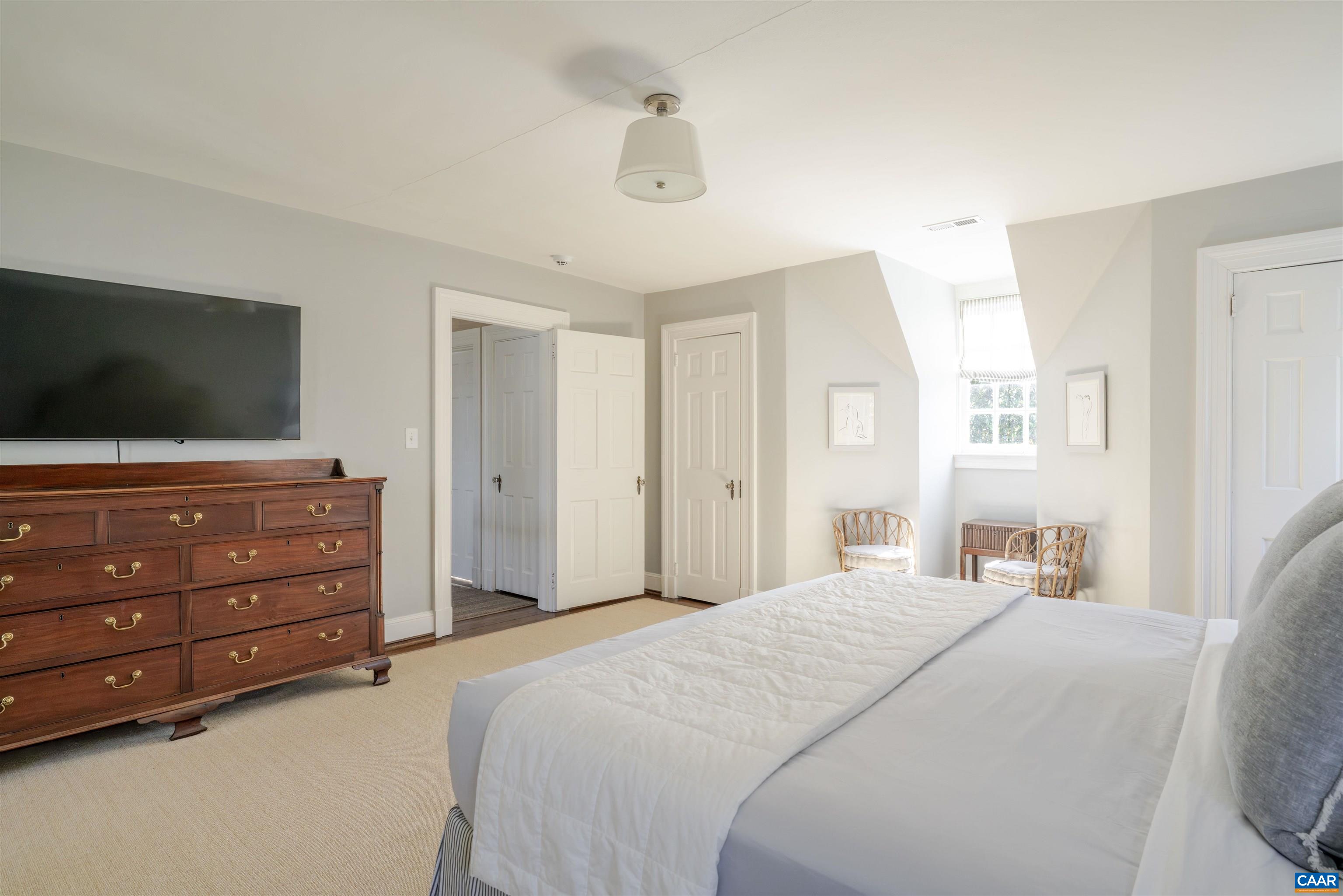 921 Rugby Road Charlottesville, VA 22903 - Photo 28 of 41 a bedroom with a bed and a flat screen tv