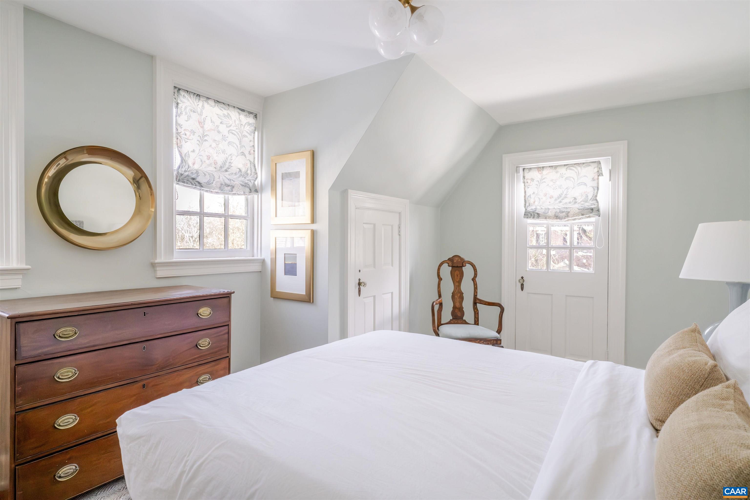 921 Rugby Road Charlottesville, VA 22903 - Photo 30 of 41 a bedroom with a bed and a large window