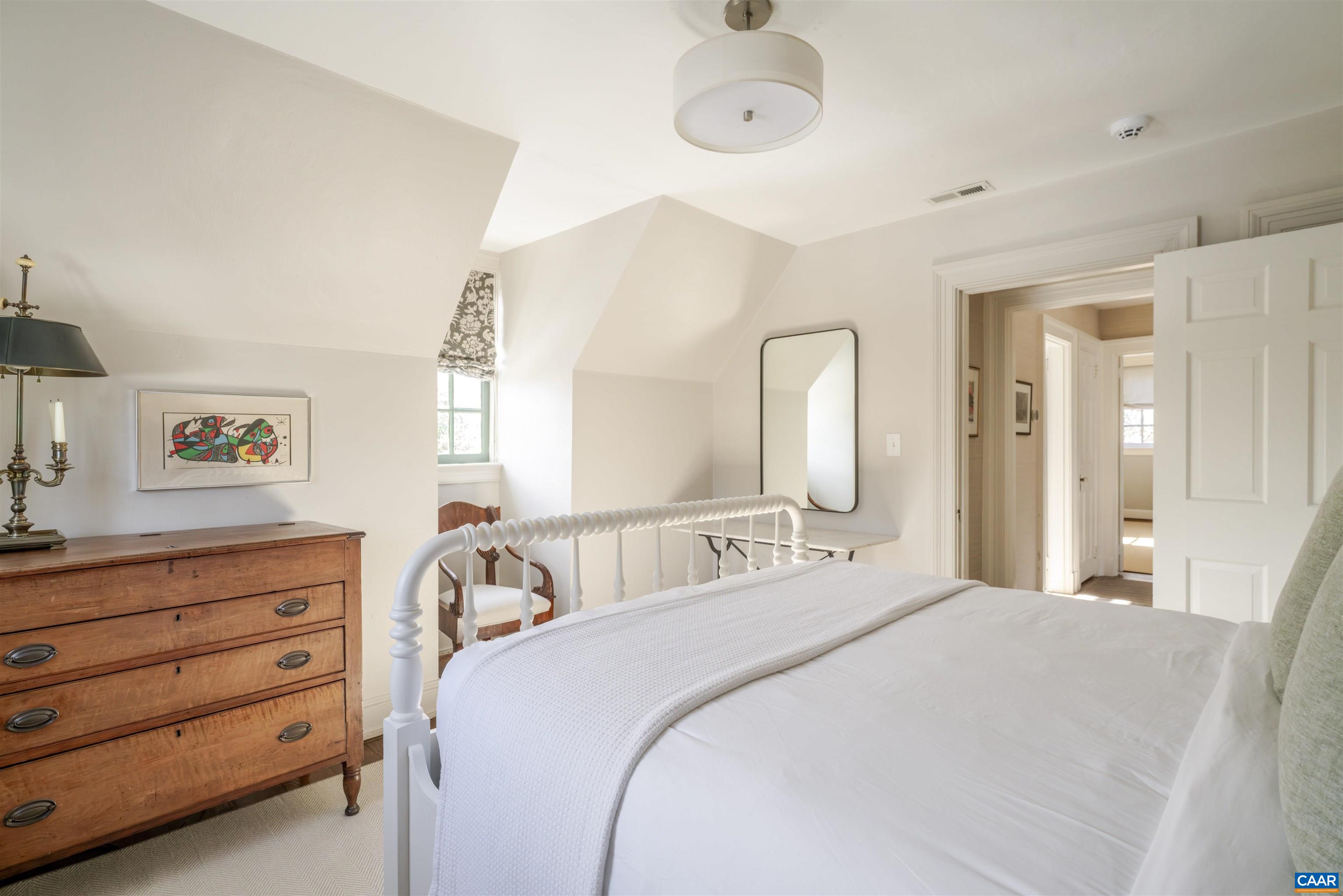 921 Rugby Road Charlottesville, VA 22903 - Photo 35 of 41 a bedroom with a bed and a dresser