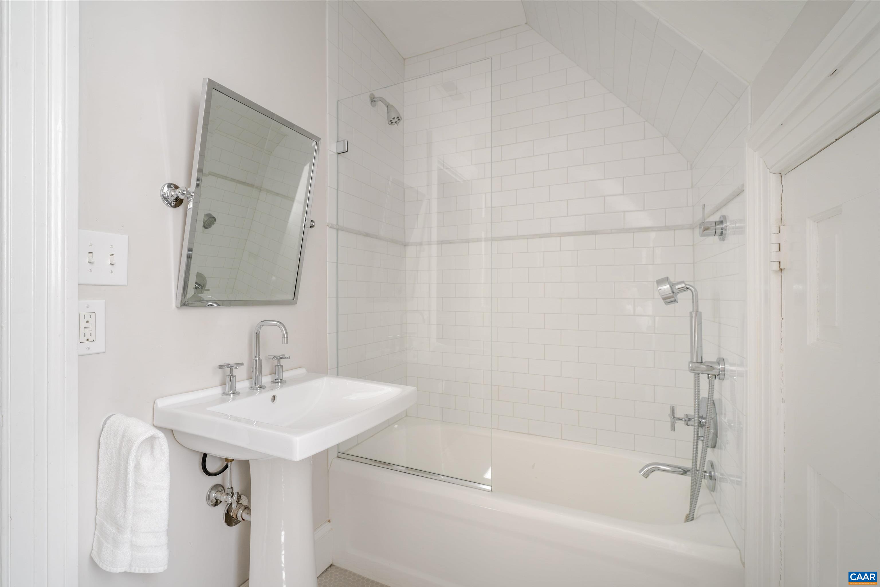 921 Rugby Road Charlottesville, VA 22903 - Photo 36 of 41 a bathroom with a sink a mirror and a bathtub