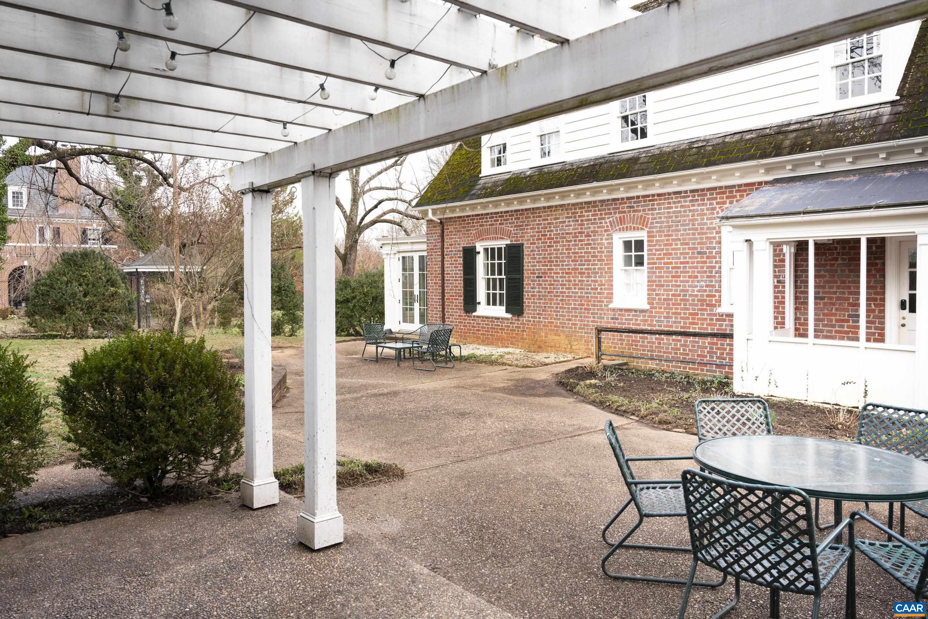 921 Rugby Road Charlottesville, VA 22903 - Photo 39 of 41 a patio with a table and chairs and potted plants