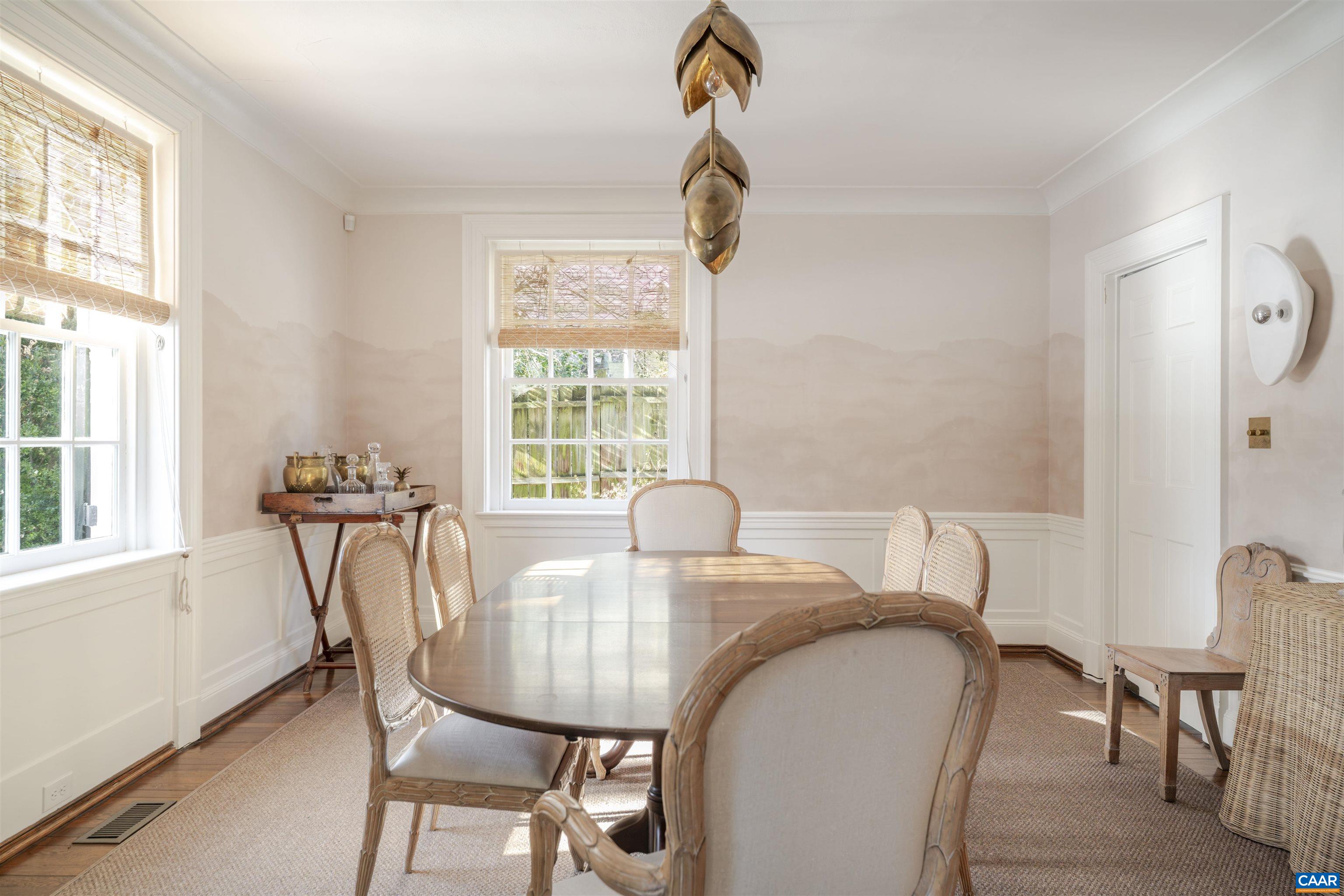 921 Rugby Road Charlottesville, VA 22903 - Photo 8 of 41 a view of a dining room with furniture and windows
