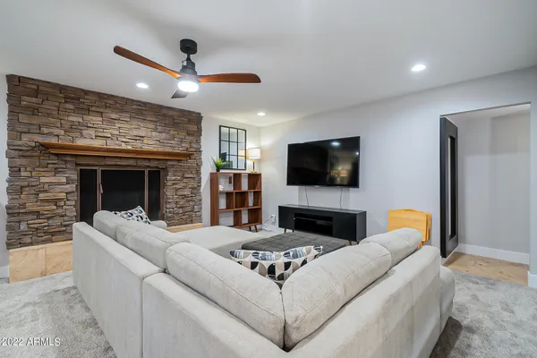 a bedroom with furniture and a wooden floor