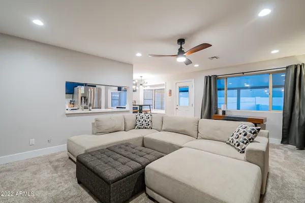 a view of a workspace with furniture and a window