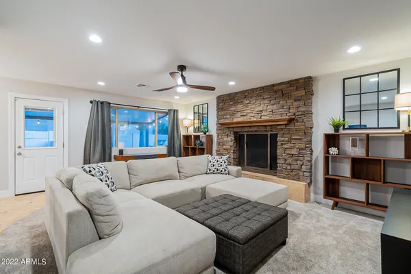 a view of a workspace with furniture and a window