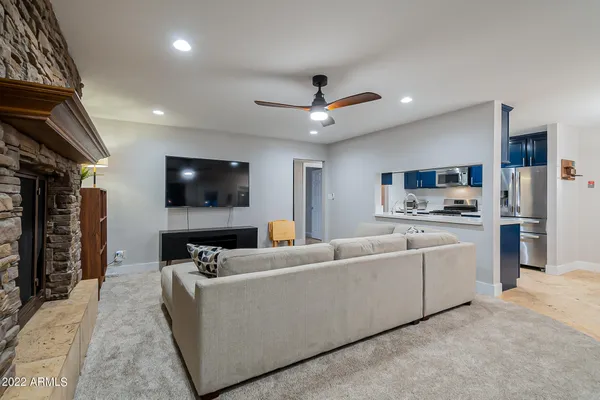 an empty room with closet and a chandelier fan