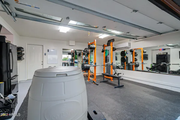 a view of a house with a yard and a large tree