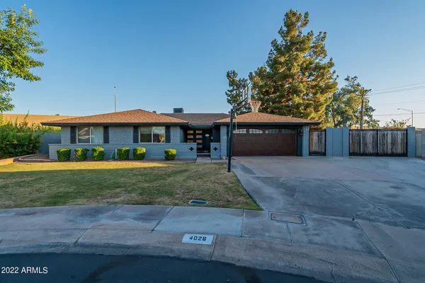a living room with furniture a flat screen tv and kitchen view