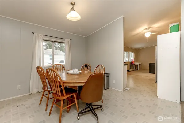a dining room with furniture and window