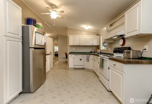 a kitchen with stainless steel appliances a refrigerator sink and cabinets